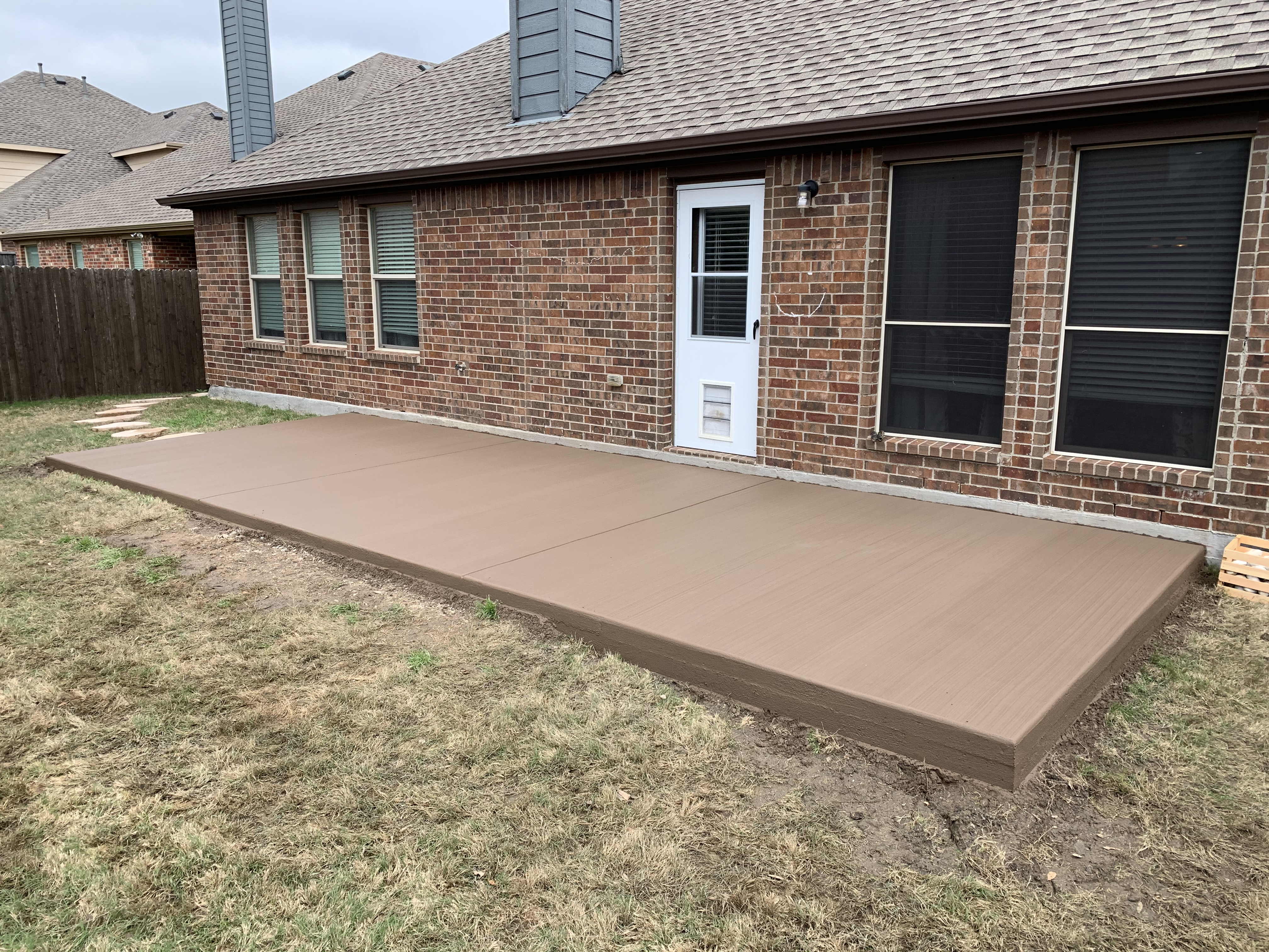 Outdoor living area with patio and backyard space